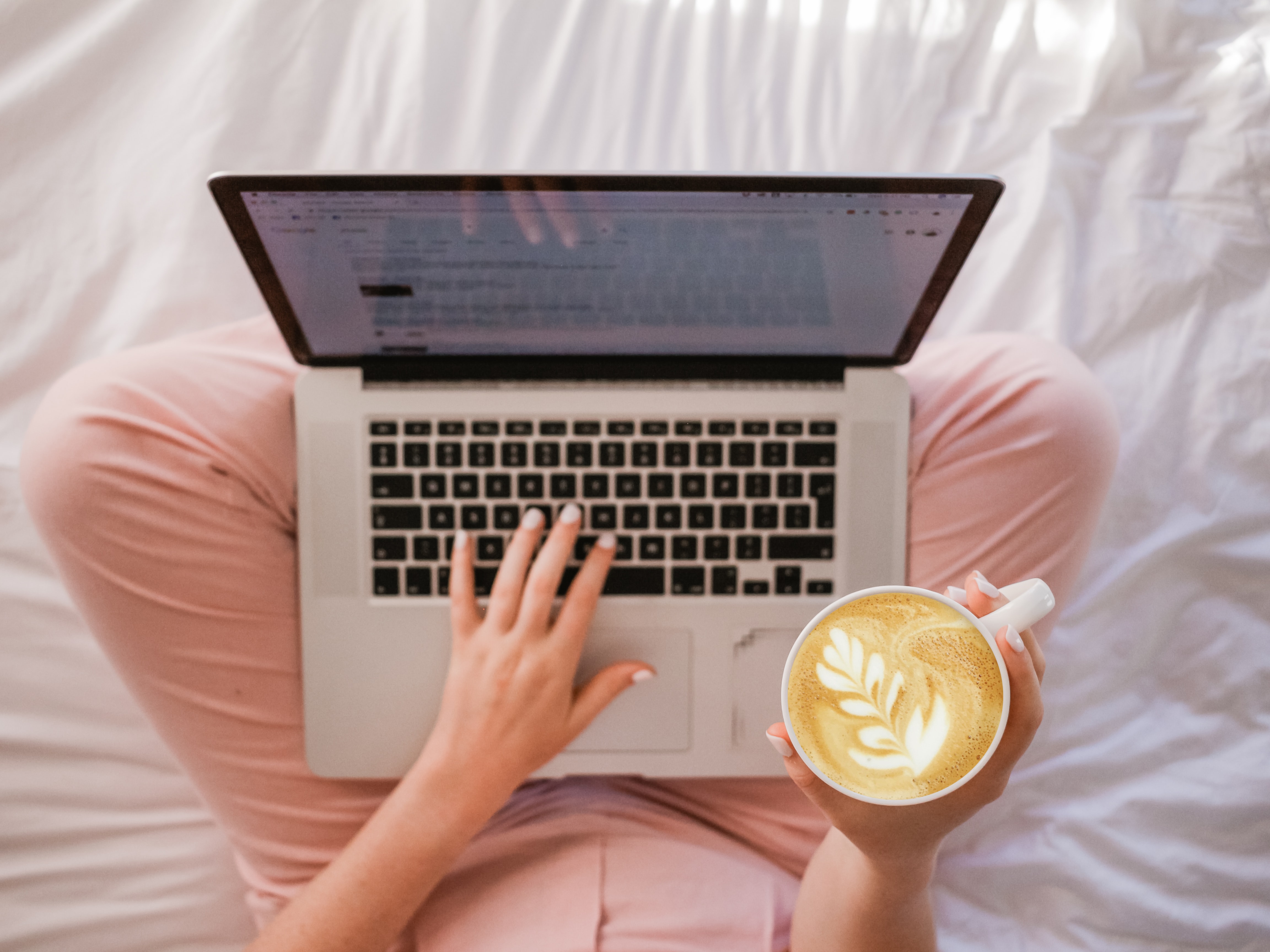 white-bed-notebook-cup-of-cappuccino-woman-writing-hands